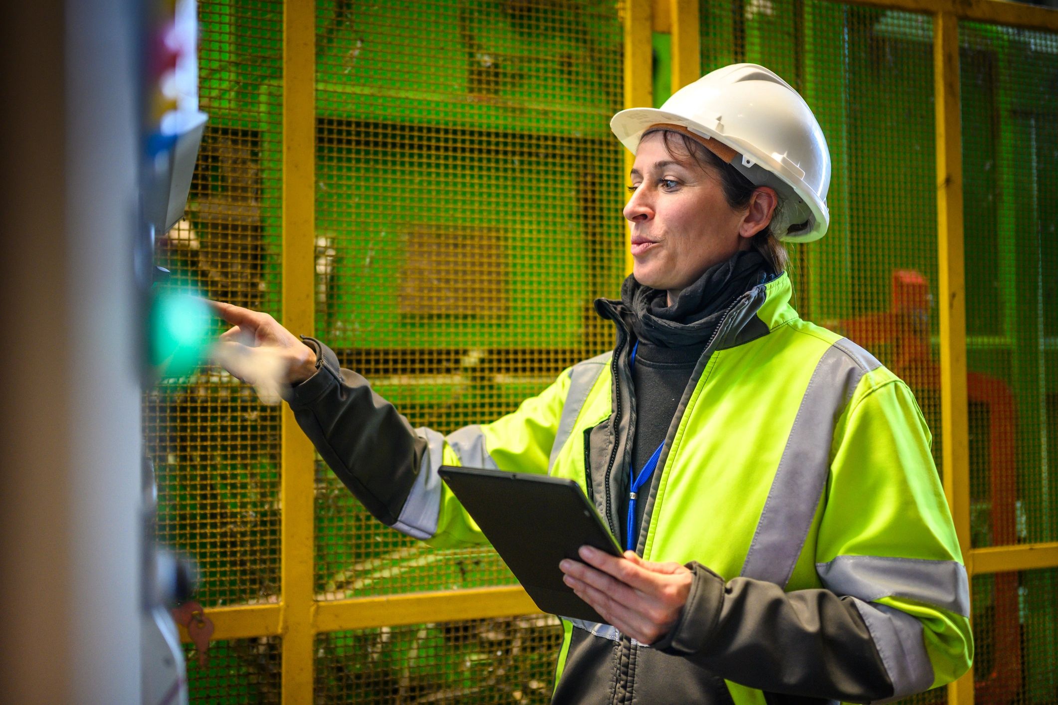Engineer inspecting equipment with a tablet